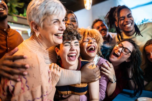 Diverse group of joyful women laughing and hugging together